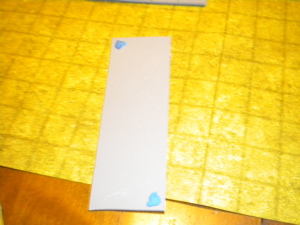 Apply tack to back of tile