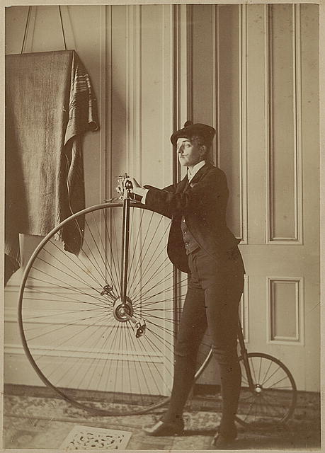 Frances Benjamin Johnston, full-length self-portrait dressed as a man with false moustache, posed with bicycle, facing left: Johnston (Frances Benjamin) Collection, Prints &amp; Photographs Division, Library of Congress, LC-DIG-ppmsc-04884